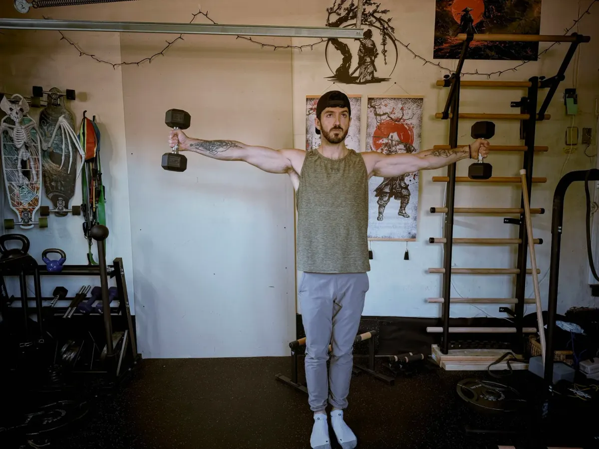 Straight-arm dumbbell hold with both arms extended out to the sides